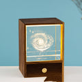 Crystal sphere LED night light glowing warm on wooden base